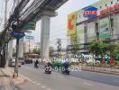 Street view with nearby shops and road traffic