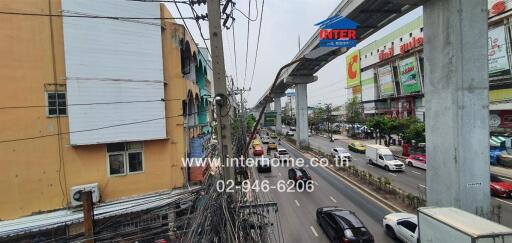 View of a busy street with buildings and cars