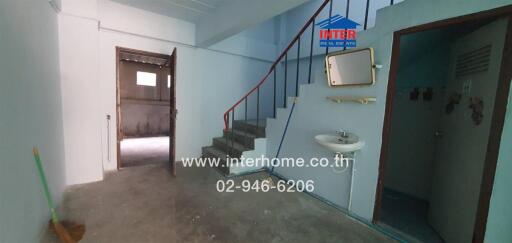 Indoor view showing a staircase, sink, and doorway