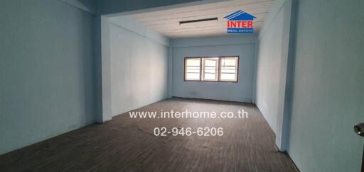 Unfurnished room with wooden floor and large windows