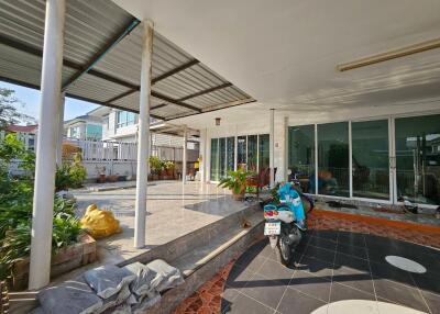 Outdoor patio with a motorbike and plants