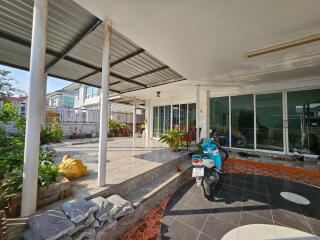 Outdoor patio with a motorbike and plants