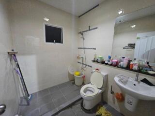 Modern bathroom with various toiletries and cleaning supplies