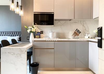 Modern kitchen with breakfast bar and adjacent bedroom