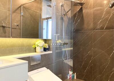 Modern bathroom with glass shower and decorative lighting