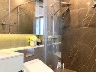 Modern bathroom with glass shower and decorative lighting