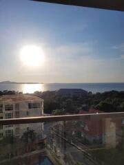 View from balcony overlooking the ocean at sunset