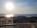 View from balcony overlooking the ocean at sunset