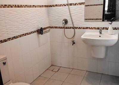 Bathroom with tile flooring, sink, toilet, and shower