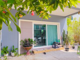 front view of a house with a sliding glass door and plants