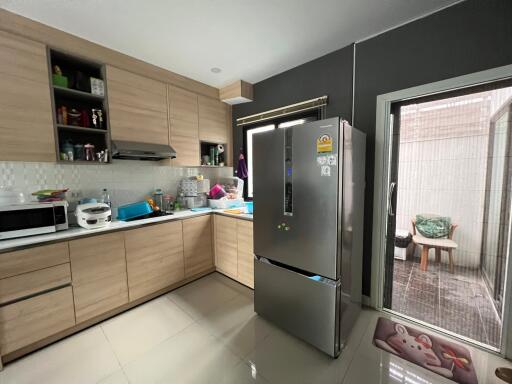 Modern kitchen with wooden cabinets and stainless steel appliances