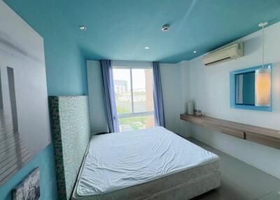 Spacious bedroom with teal ceiling, large window, and modern decor