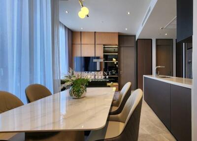 Modern living and dining area with a large window, contemporary decor, and an integrated kitchen