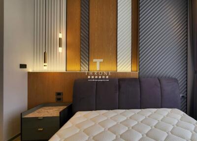 Modern bedroom with stylish wall paneling and cozy bed