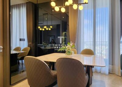 Modern dining area with a table, chairs, and decorative lighting
