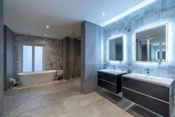 Modern bathroom with double vanity and bathtub