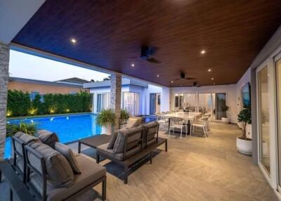 Modern outdoor patio with pool and dining area