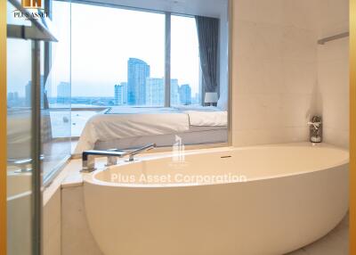 Modern bathroom with a bathtub offering city views