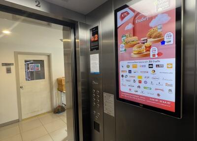 Elevator interior with digital advertising screen