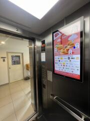 Elevator interior with digital advertising screen