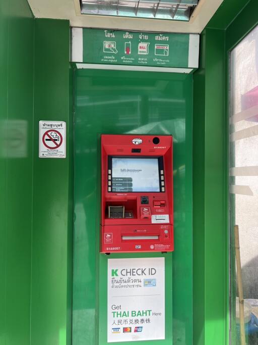 ATM machine in a green booth