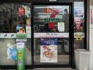 Entrance of a store with glass doors and advertisements