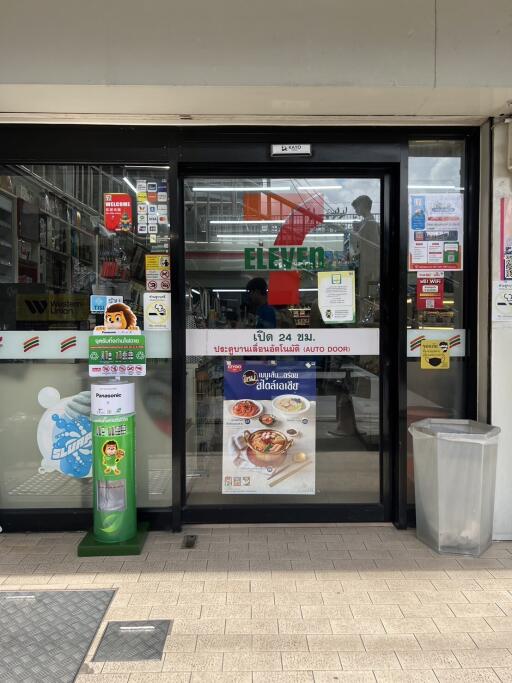 Entrance of a store with glass doors and advertisements