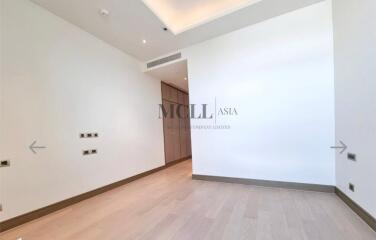 Modern empty bedroom with wooden flooring and recessed lighting