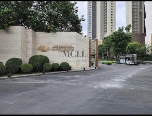 Entrance to the residential building with driveway and landscaped garden