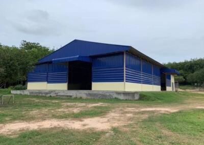 Large blue industrial building with open doors