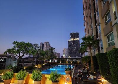 Outdoor area with pool and cityscape view