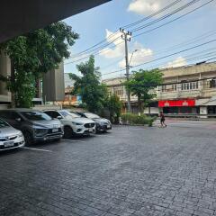 Parking lot with cars and view of nearby buildings