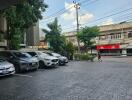 Parking lot with cars and view of nearby buildings