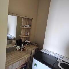 Small laundry room with vanity and washing machine