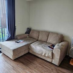 Cozy living room with an L-shaped sofa and wooden floors