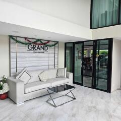 Lobby area with a sofa, glass table, and building sign