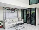 Lobby area with a sofa, glass table, and building sign