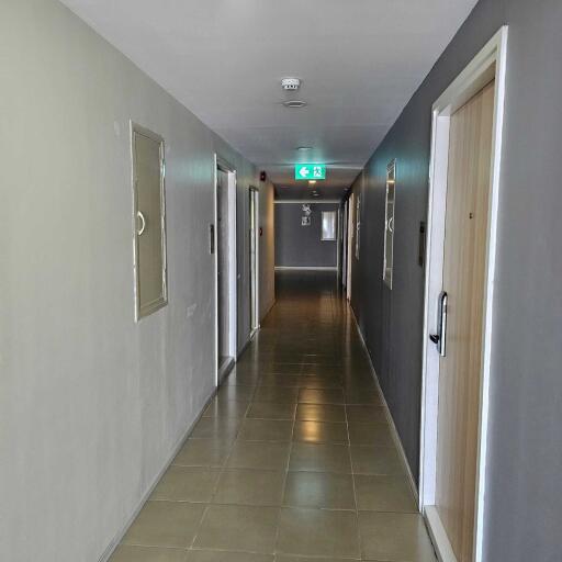 Hallway with doors and exit sign