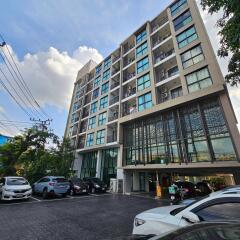 Modern apartment building exterior with parking lot