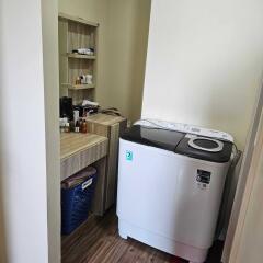 Utility room with washing machine and storage shelf