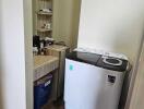 Utility room with washing machine and storage shelf
