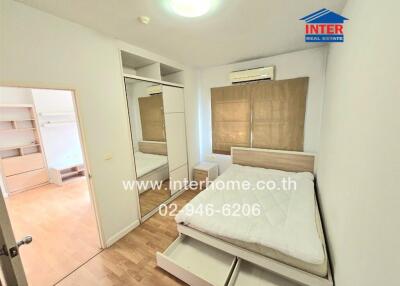 Bedroom with built-in wardrobe and air conditioner