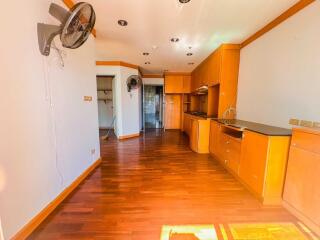 Modern kitchen with wooden cabinetry and built-in fan