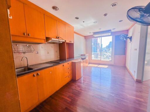 Modern kitchen with built-in cabinets and large window