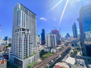 Cityscape with high-rise buildings under a clear blue sky