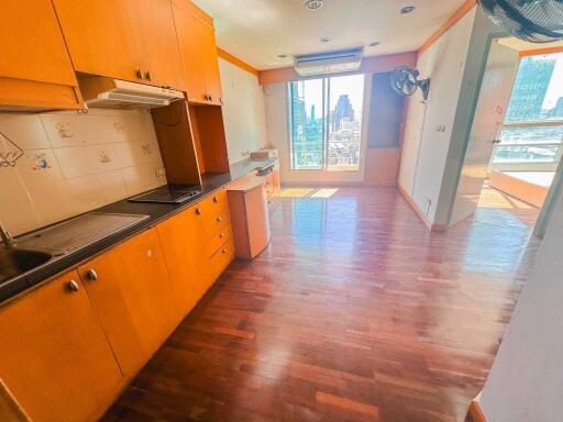 Modern kitchen with wooden cabinets and city view