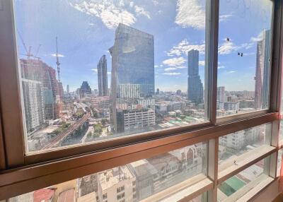 View of the cityscape from a high-rise building window