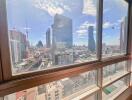 View of the cityscape from a high-rise building window