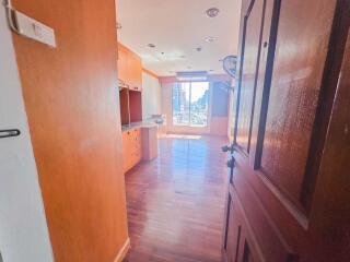 Spacious kitchen with wooden cabinets and flooring