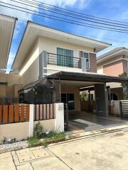 Two-story modern house with balcony and carport